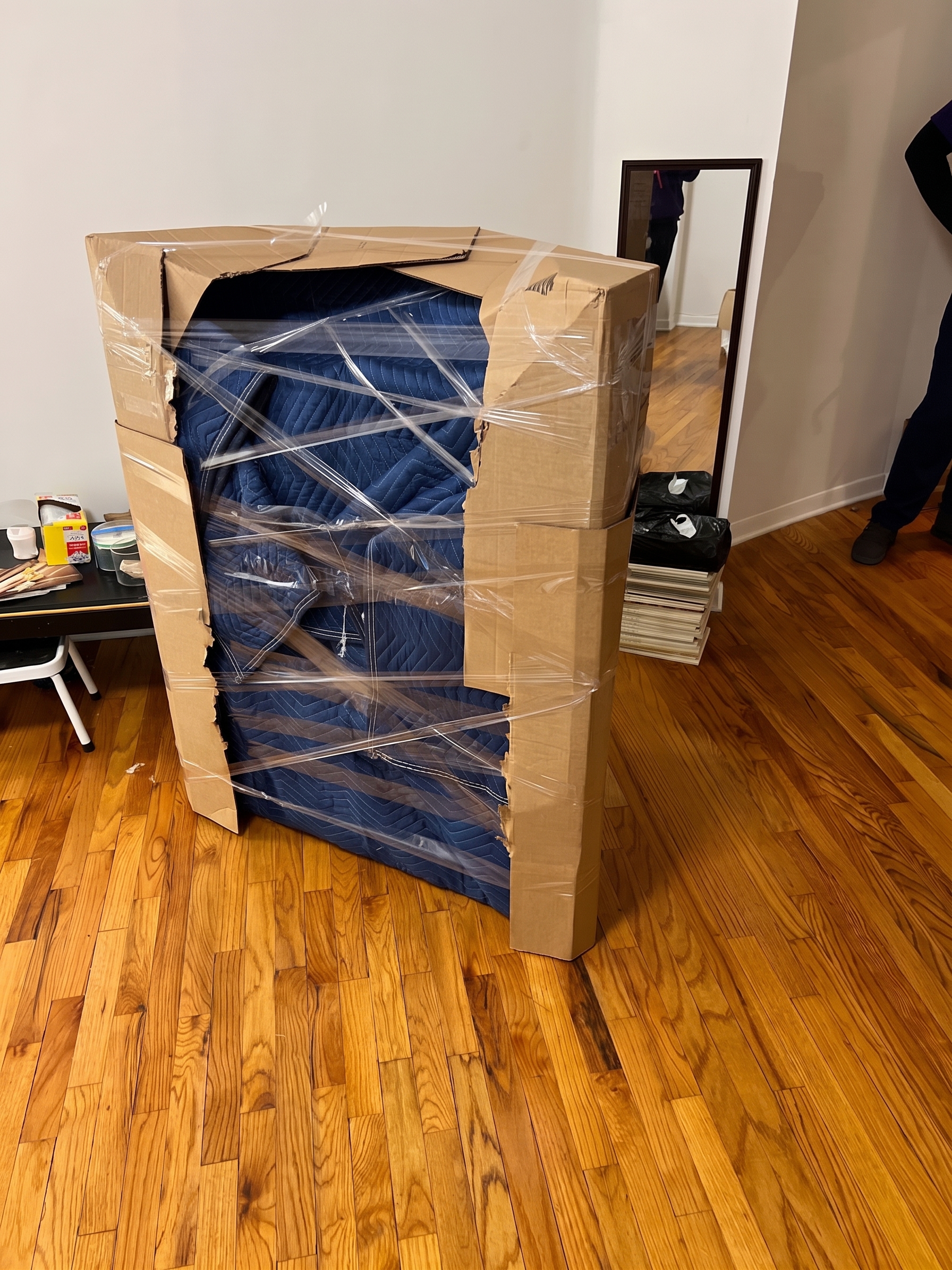 Fragile item protected with blankets and cardboard corners